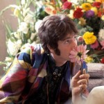 John Lennon sniffs a flower while visiting Maharishi Mahesh Yogi, 1967