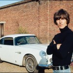 George Harrison next to his Aston Martin at his home in Esher, 1965