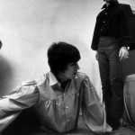 George Harrison playing monopoly during the Beatles tour of the USA. Ringo Starr smoking a cigarette in the background at rented Bel Air home August 1964