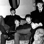 The Beatles sitting on a sofa