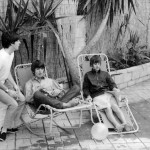 relax on sun loungers at their rented house in Bel Air, Los Angeles, 24 August 1964 during a break in the Beatles' first concert tour of America